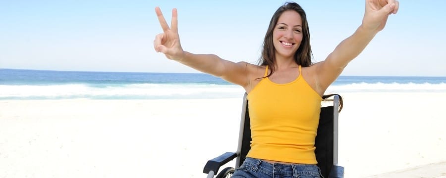 Woman happy in wheelchair because of Tax free for critical illness
